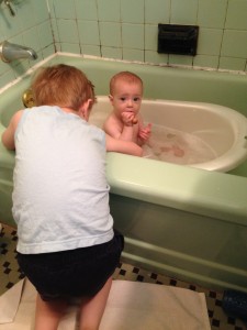 Max playing with Nathaniel as he gets a bath.
