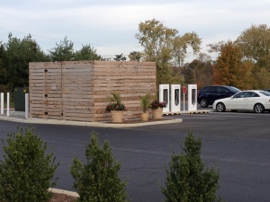 There is something strange with this photo. This is our local Tesla charging station. I have no problem with that. It just seems to me that an electric car wouldn't need the HUGE "danger high voltage" box right next to it. They should be able to make it cleaner then that. 