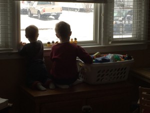 The boys watching it snow.