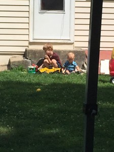 The boys playing in the sand.