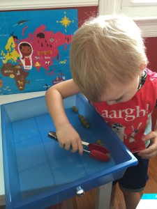 Fine motor control with beads and tongs. 